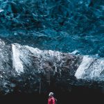 Glacier Guide standing inside sapphire ice cave