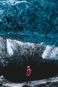Glacier Guide standing inside sapphire ice cave